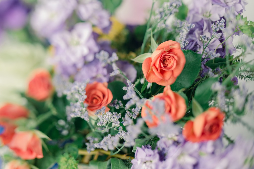 Summer garden bouquet with orange and purple photographed in studio with natural light by photographer Brenda Landrum