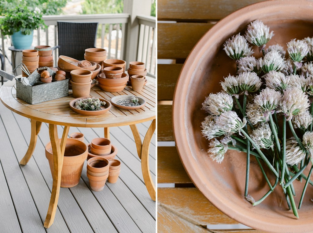 Potting table on covered deck with loads of terracotta pots and metal garden decor